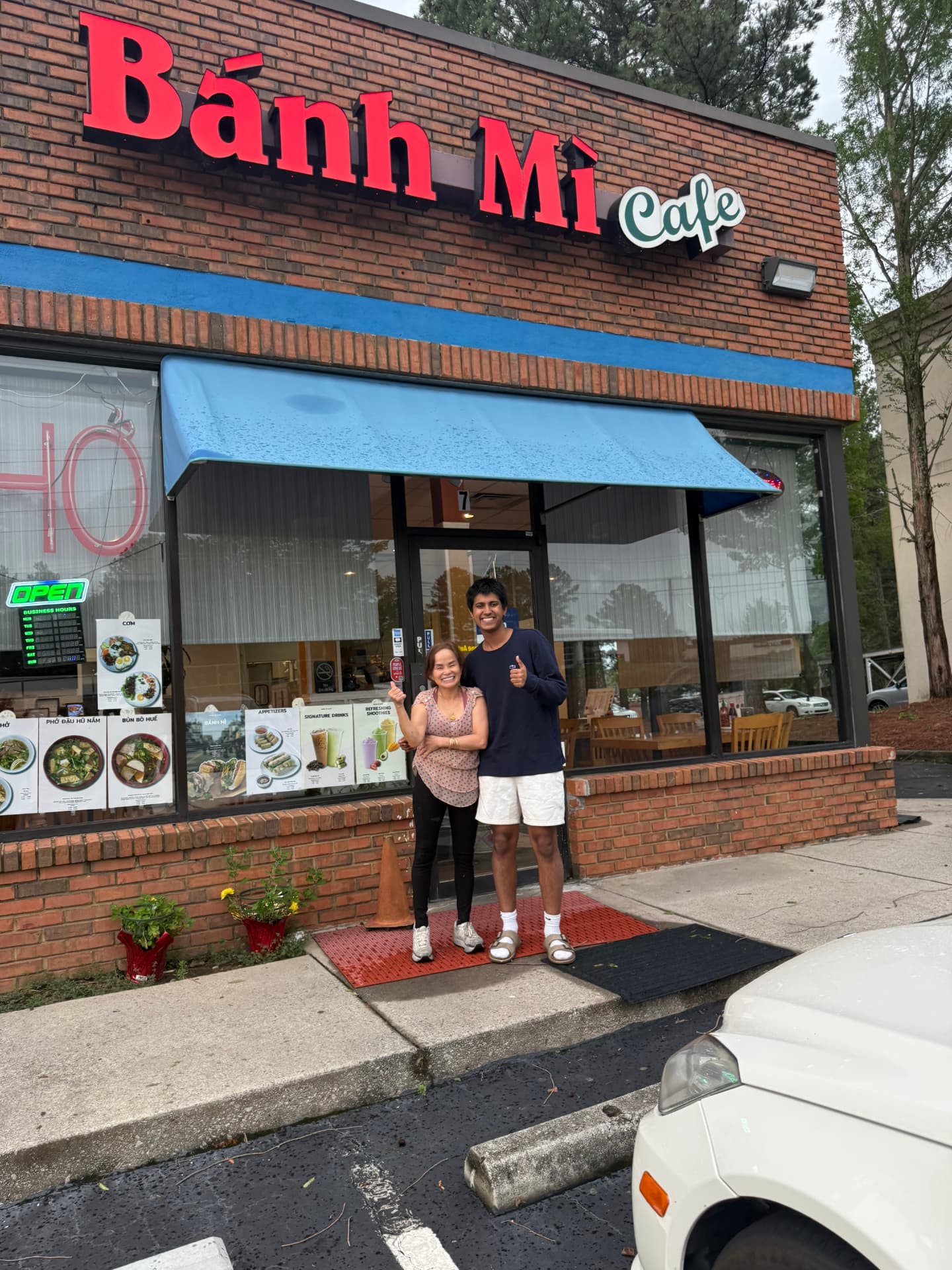 The TableSide team with the owner of Bánh Mì Cafe in front of their restaurant entrance