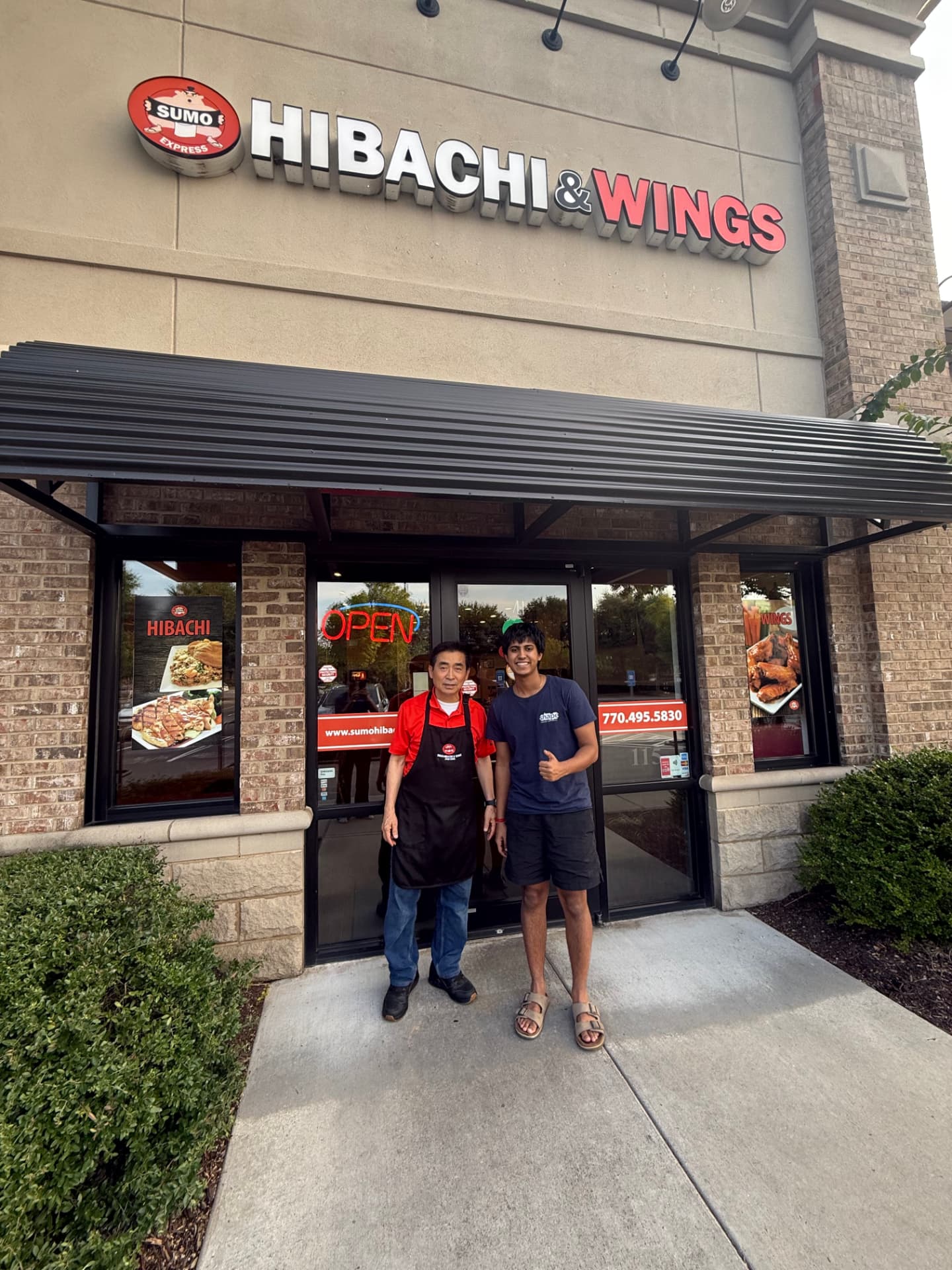 TableSide's founder with the owner of Sumo Hibachi & Wings in front of their Suwanee storefront
