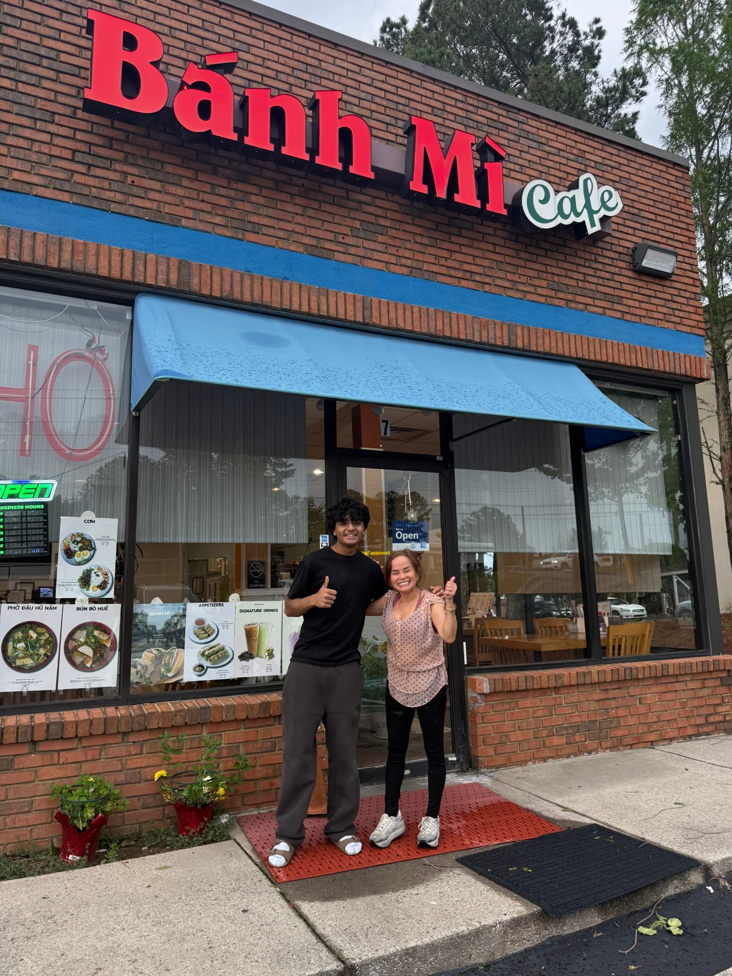 The TableSide team with the owners of Bánh Mì Cafe in front of their storefront